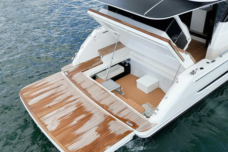 Slide: The Image of 2026 Maritimo M55 yacht with elegant teak deck and spacious swim platform. - 60