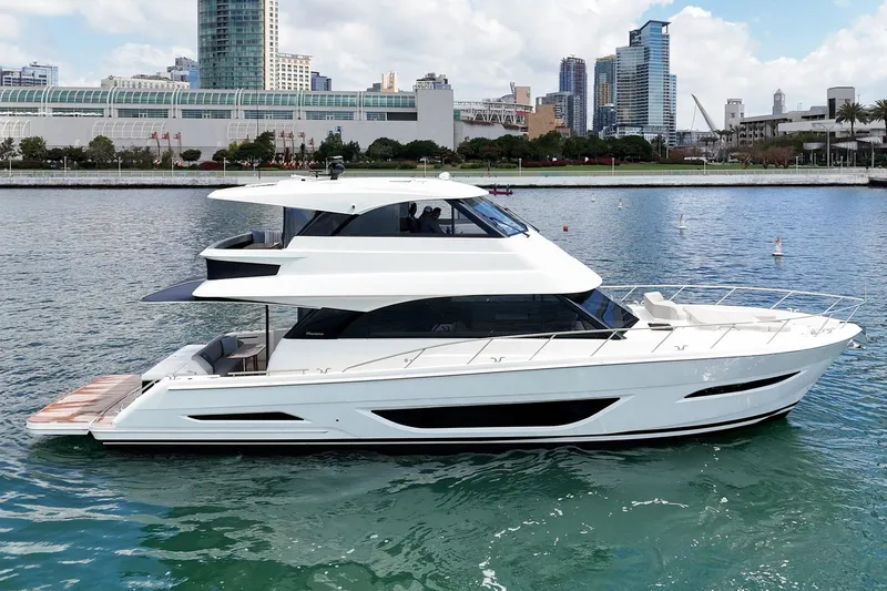 Slide: The Image of 2026 Maritimo M55 yacht cruising in urban waterfront setting. - 62