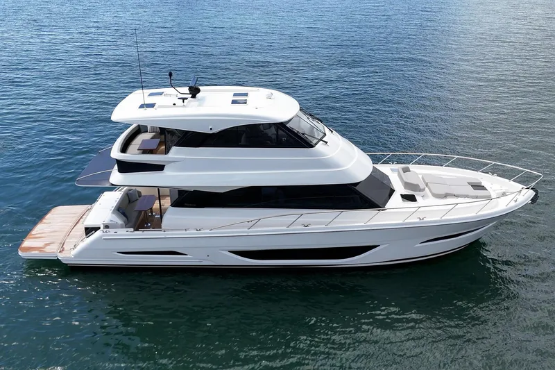 Slide: The Image of 2026 Maritimo M55 luxury yacht cruising on calm blue waters. - 63