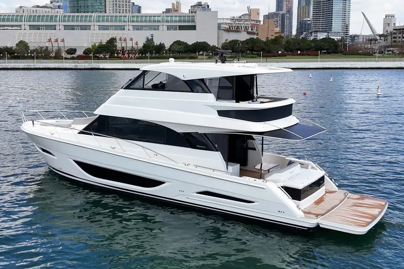 Slide: The Image of 2026 Maritimo M55 yacht on water near urban skyline. - 64