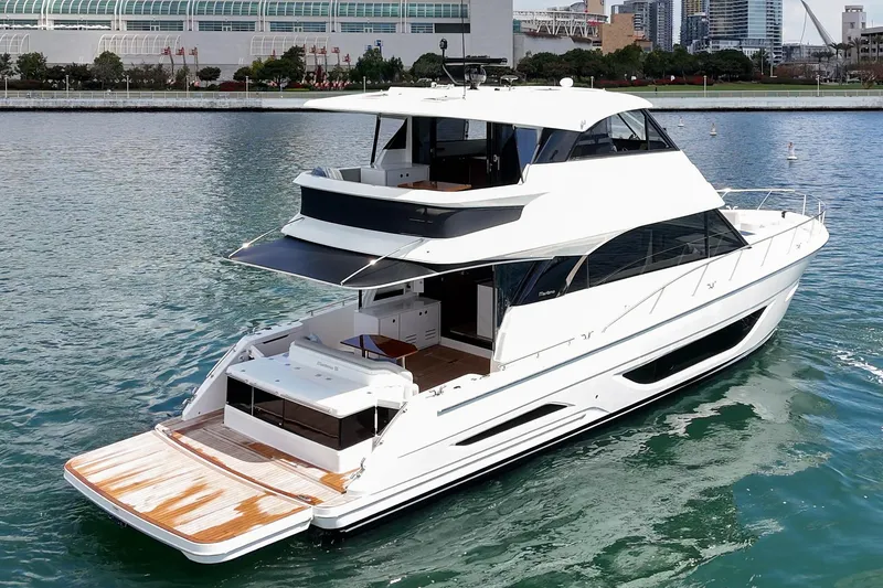 Slide: The Image of 2026 Maritimo M55 yacht cruising on a calm waterfront near urban skyline. - 66