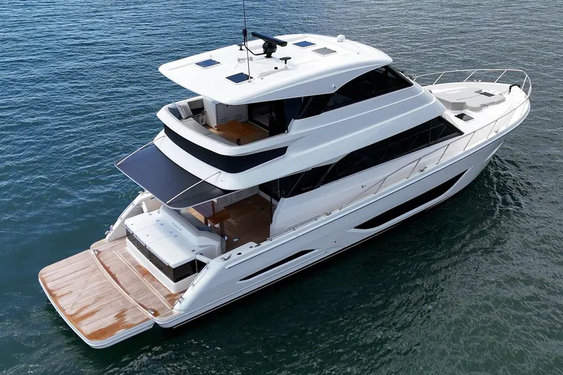 Slide: The Image of 2026 Maritimo M55 luxury yacht on calm blue water, showcasing sleek design and spacious decks. - 67