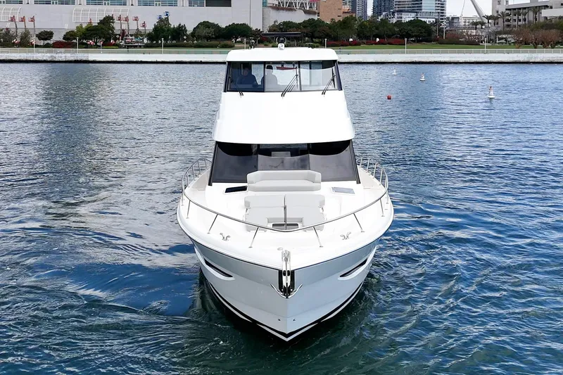 Slide: The Image of 2026 Maritimo M55 yacht cruising on calm waters near urban waterfront. - 69