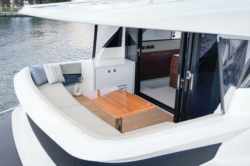 Slide: The Image of 2026 Maritimo M55 yacht with elegant outdoor seating and wooden table. - 71