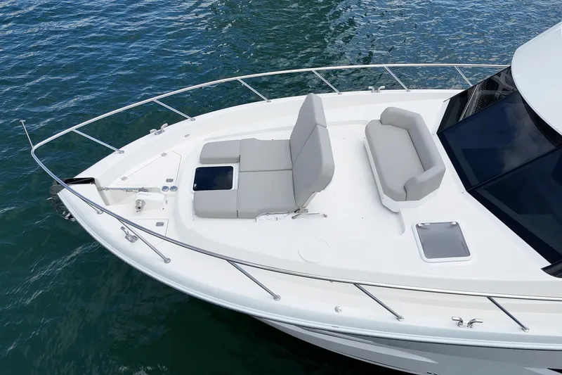 Slide: The Image of 2026 Maritimo M55 yacht bow with seating, on calm water. - 74