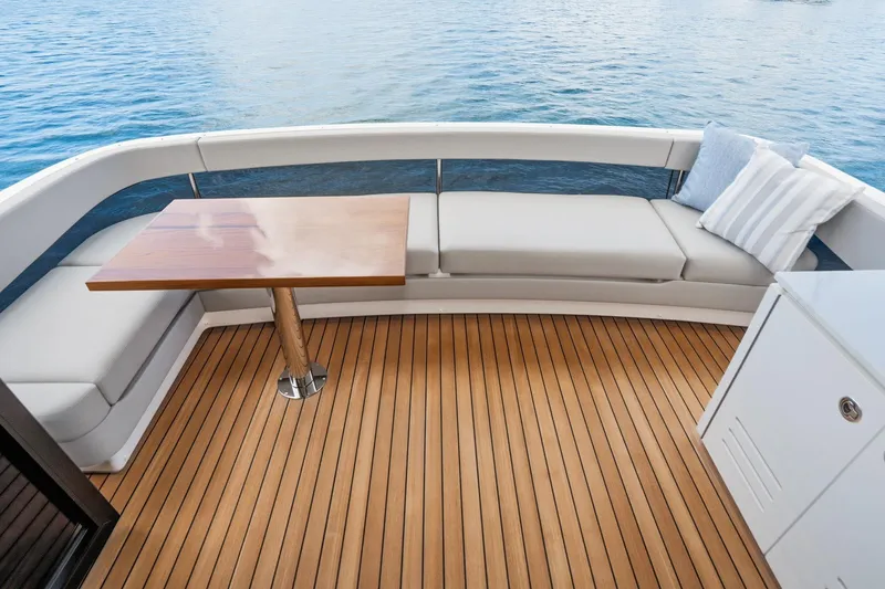 Slide: The Image of Luxurious deck seating on 2026 Maritimo M55 yacht with wooden table and ocean view. - 78