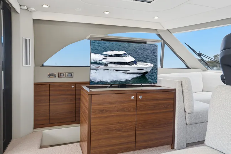 Slide: The Image of Luxurious interior of 2026 Maritimo M55 yacht with TV displaying yacht image. - 81