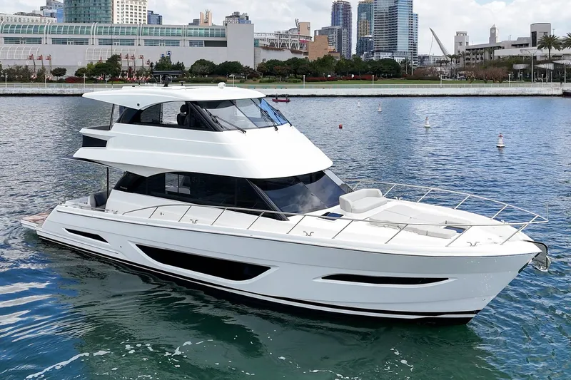 Slide: The Image of 2026 Maritimo M55 luxury yacht cruising in a scenic urban harbor. - 88