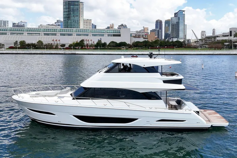 Slide: The Image of 2026 Maritimo M55 yacht cruising in urban waterfront setting. - 90