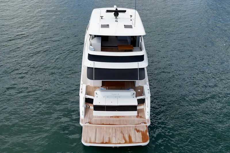 Slide: The Image of 2026 Maritimo M55 yacht on water, rear view showcasing deck and sleek design. - 92