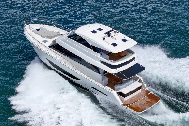 Slide: The Image of 2026 Maritimo M55 yacht cruising on open water, showcasing sleek design and luxury features. - 96
