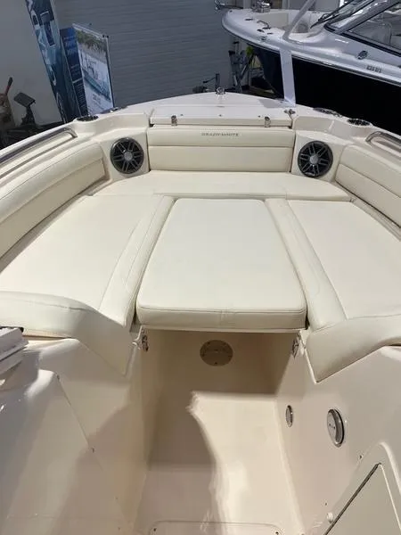 Slide: The Image of 2024 Grady-White Freedom 215 boat interior with cushioned seating and speakers. - 13