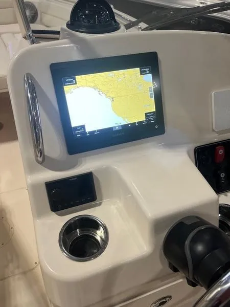Slide: The Image of 2024 Grady-White Freedom 215 boat dashboard with navigation screen and cup holder. - 5