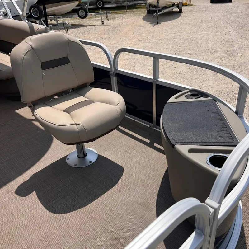 Slide: The Image of 2023 Sun Tracker Party Barge 18 DLX interior with seating and console. - 11