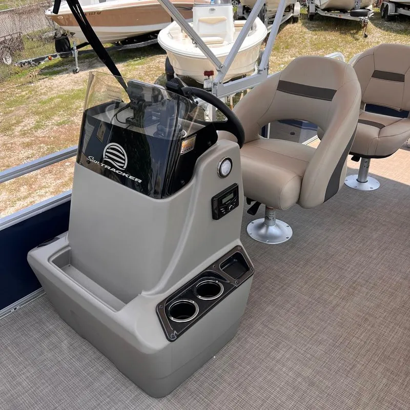 Slide: The Image of 2023 Sun Tracker Party Barge 18 DLX interior with captain's chair and console. - 12