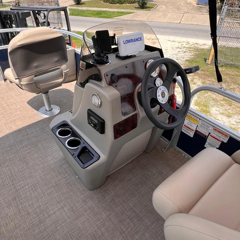 Slide: The Image of 2023 Sun Tracker Party Barge 18 DLX helm with Lowrance electronics and comfortable seating. - 14