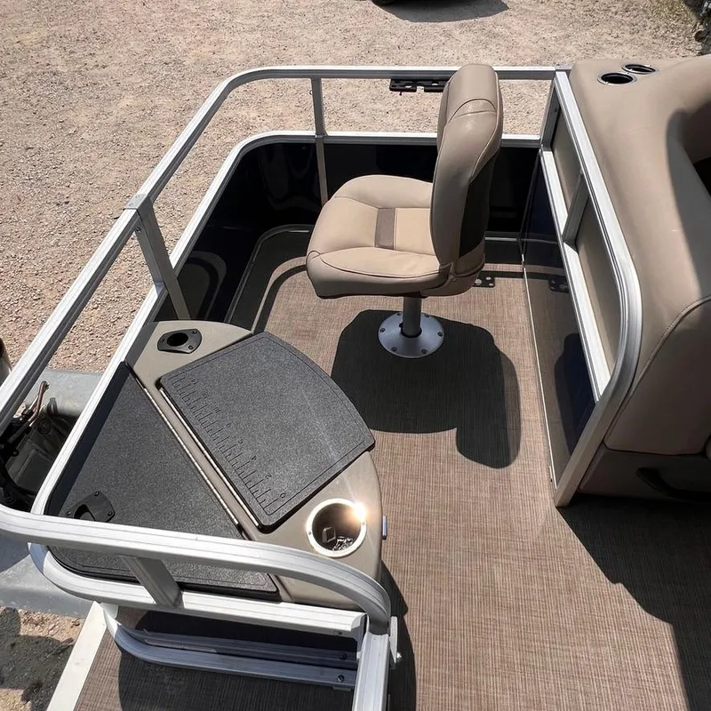 Slide: The Image of 2023 Sun Tracker Party Barge 18 DLX interior with seating and console. - 15
