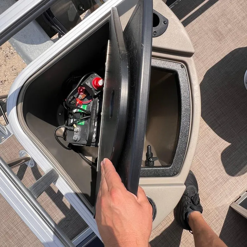 Slide: The Image of 2023 Sun Tracker Party Barge 18 DLX battery compartment with lid open. - 16