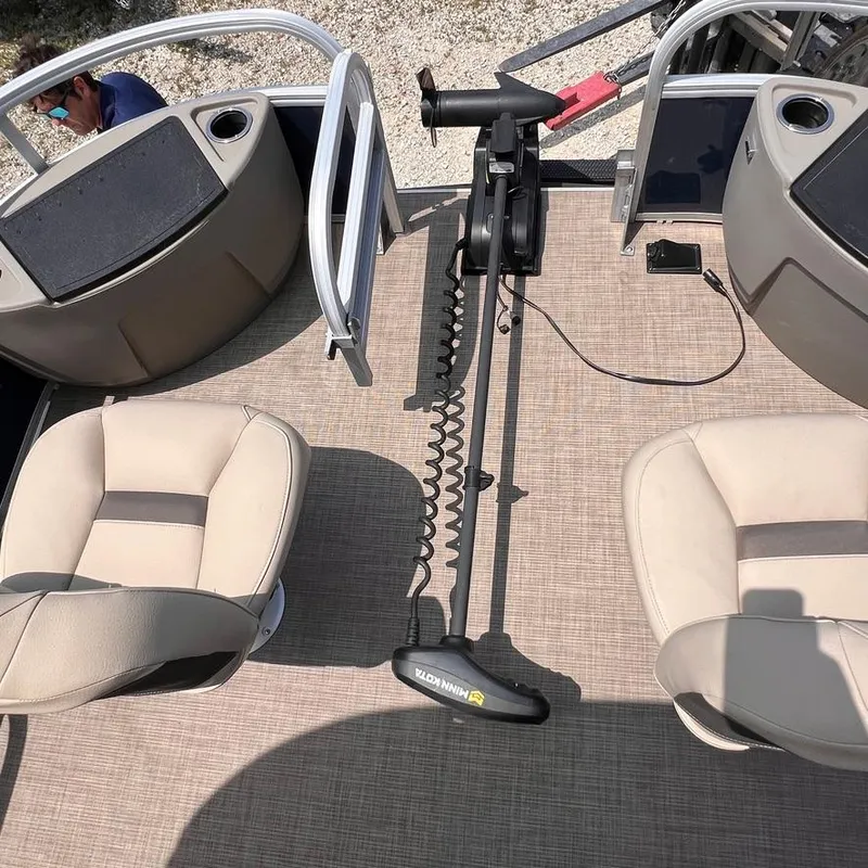 Slide: The Image of 2023 Sun Tracker Party Barge 18 DLX interior with seating and trolling motor. - 22