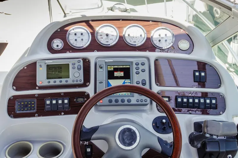 Slide: The Image of 2004 Chaparral Signature 310 boat dashboard with gauges, GPS, and control panels. - 17