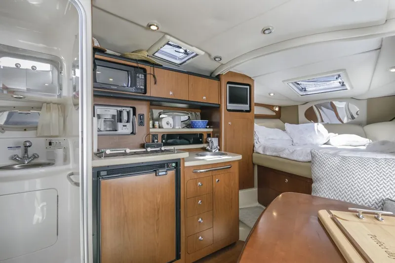 Slide: The Image of 2004 Chaparral Signature 310 yacht interior with kitchenette and sleeping area. - 18