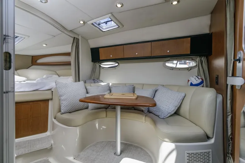 Slide: The Image of 2004 Chaparral Signature 310 cabin interior with seating area and table. - 20