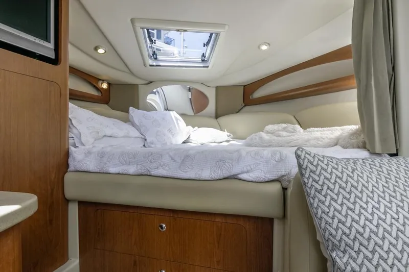Slide: The Image of 2004 Chaparral Signature 310 cabin interior with bed and skylight. - 21
