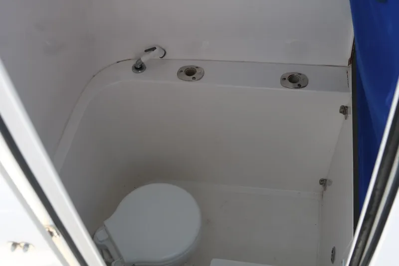 Slide: The Image of 2008 Venture 39 Center Console boat bathroom with white toilet. - 14