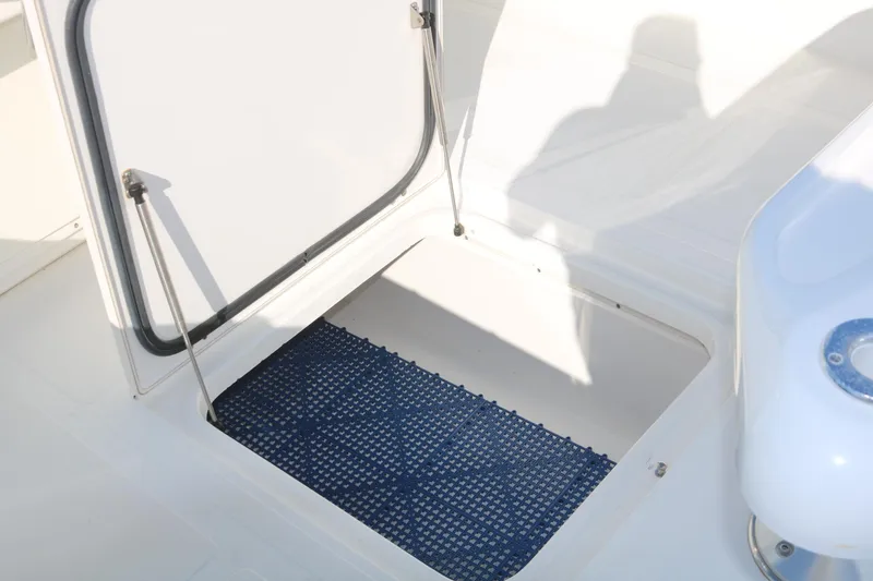 Slide: The Image of 2008 Venture 39 Center Console storage compartment with open hatch. - 18