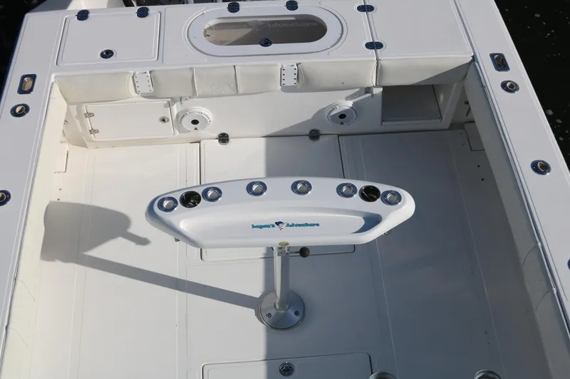 Slide: The Image of 2008 Venture 39 Center Console boat deck with rod holders and storage compartments. - 20