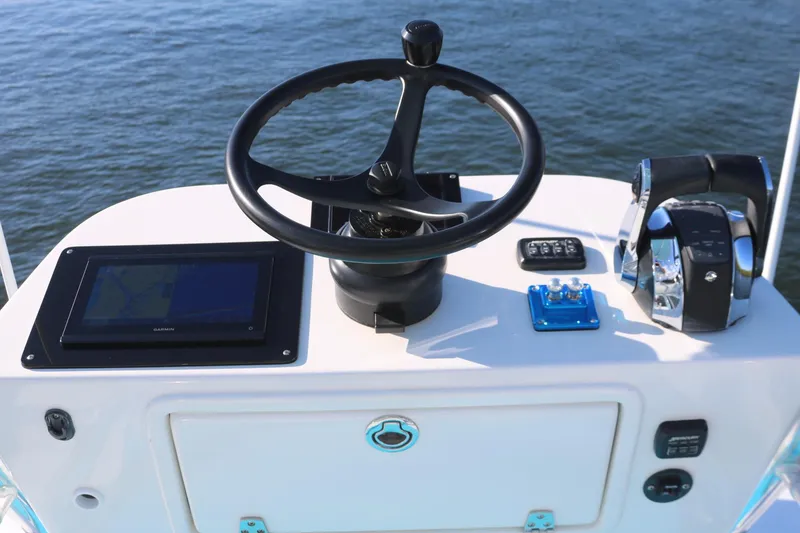 Slide: The Image of 2008 Venture 39 Center Console boat helm with steering wheel and controls. - 23