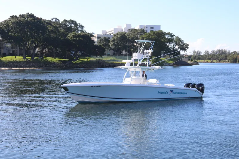 Slide: The Image of 2008 Venture 39 Center Console boat cruising on a calm river. - 26