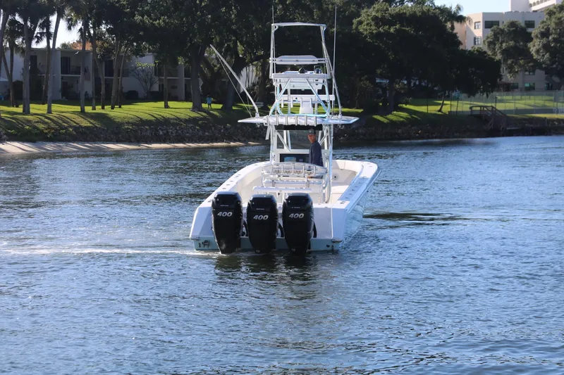 Slide: The Image of 2008 Venture 39 Center Console boat with triple 400 HP engines on a calm waterway. - 29