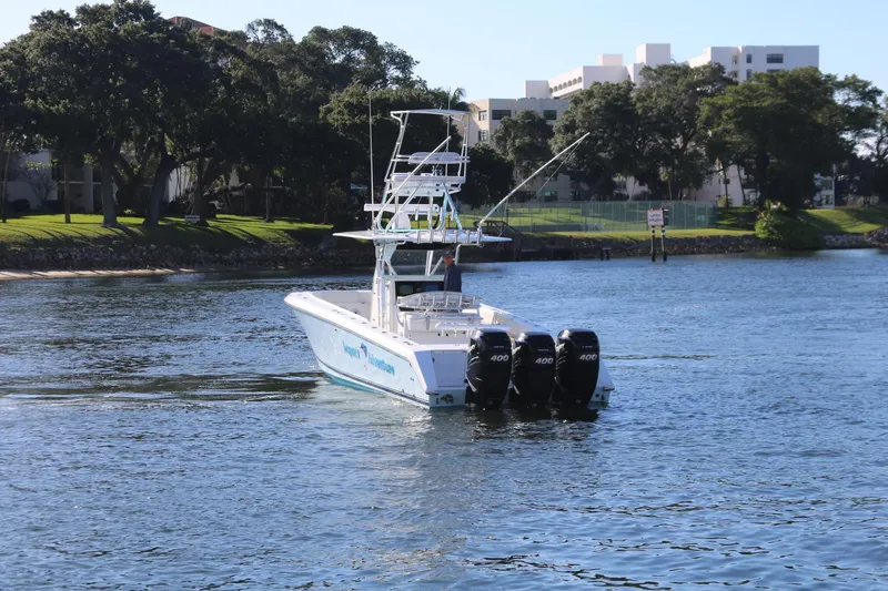 Slide: The Image of 2008 Venture 39 Center Console boat with triple outboard engines on the water. - 31