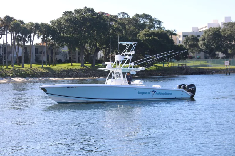 Slide: The Image of 2008 Venture 39 Center Console boat on calm water near a shoreline. - 34