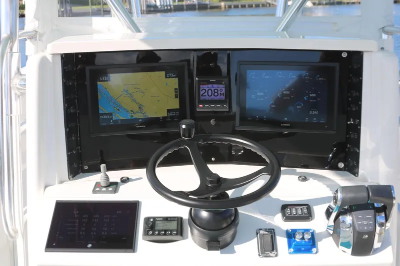 Slide: The Image of 2008 Venture 39 Center Console boat dashboard with navigation screens and controls. - 5