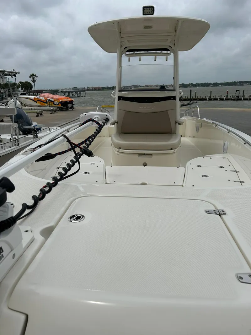 Slide: The Image of 2017 Boston Whaler 270 Dauntless boat docked, showcasing spacious deck and seating. - 15