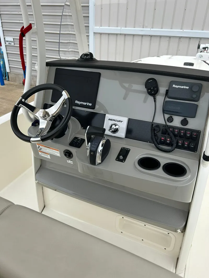 Slide: The Image of 2017 Boston Whaler 270 Dauntless boat console with steering wheel and navigation equipment. - 16