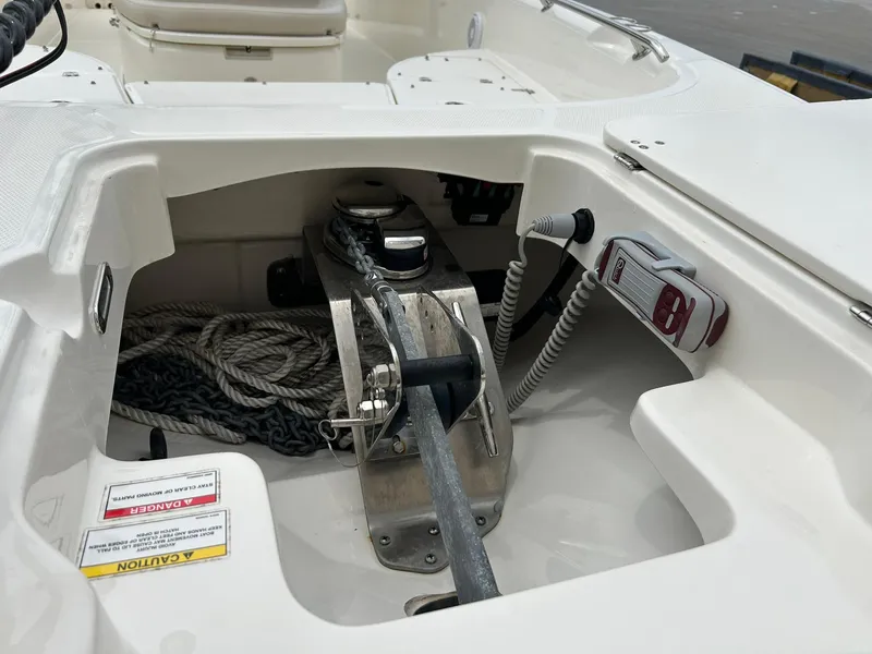 Slide: The Image of 2017 Boston Whaler 270 Dauntless anchor compartment with rope and winch system. - 17