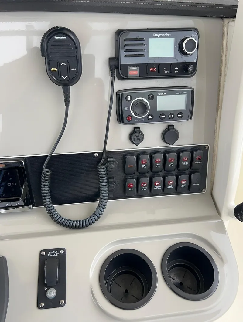 Slide: The Image of Control panel of a 2017 Boston Whaler 270 Dauntless with radio and switches. - 18