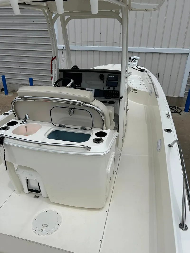 Slide: The Image of 2017 Boston Whaler 270 Dauntless boat interior with helm and seating area. - 22