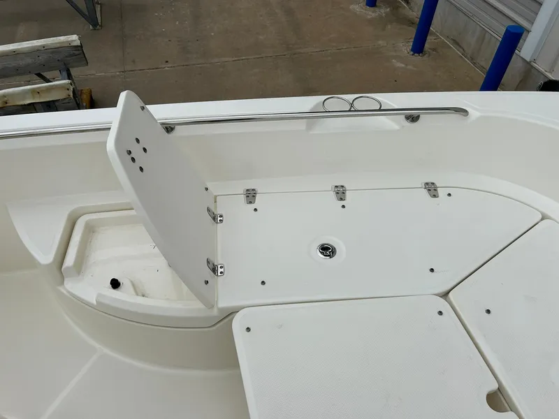 Slide: The Image of 2017 Boston Whaler 270 Dauntless boat interior with foldable seat and storage compartment. - 30
