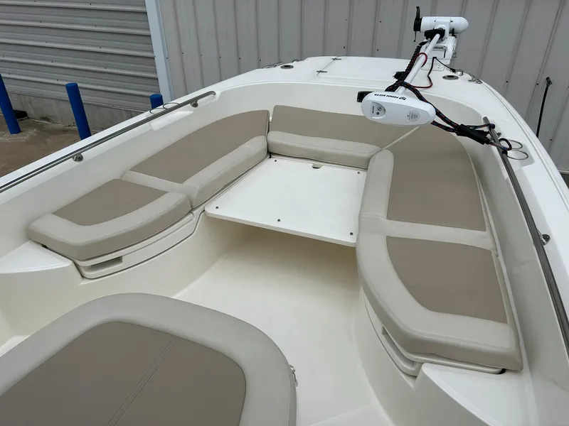 Slide: The Image of 2017 Boston Whaler 270 Dauntless boat interior with cushioned seating and mounted equipment. - 35