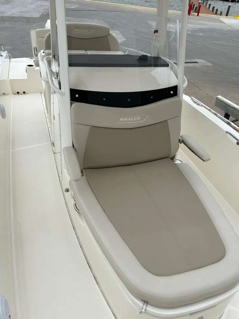 Slide: The Image of 2017 Boston Whaler 270 Dauntless boat interior with beige seating and console. - 38