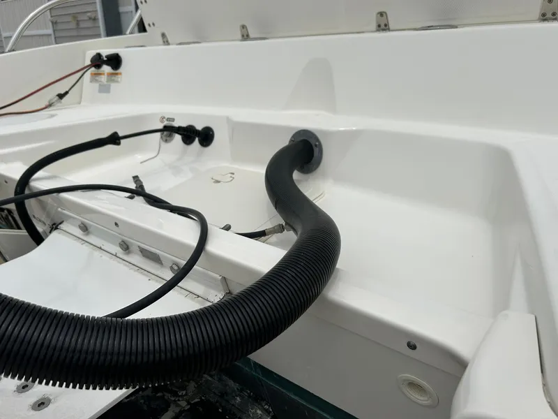 Slide: The Image of 2017 Boston Whaler 270 Dauntless boat interior with cables and hose connections. - 48