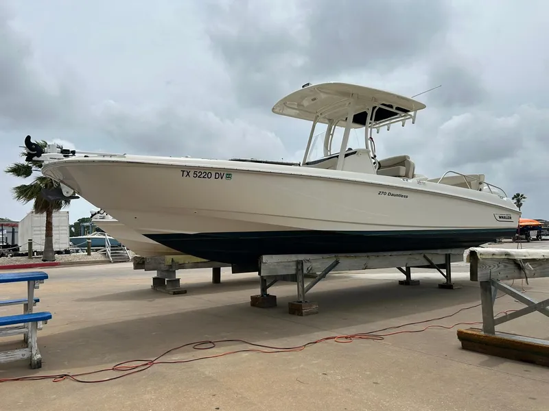 Slide: The Image of 2017 Boston Whaler 270 Dauntless boat on dry dock, overcast sky background. - 6