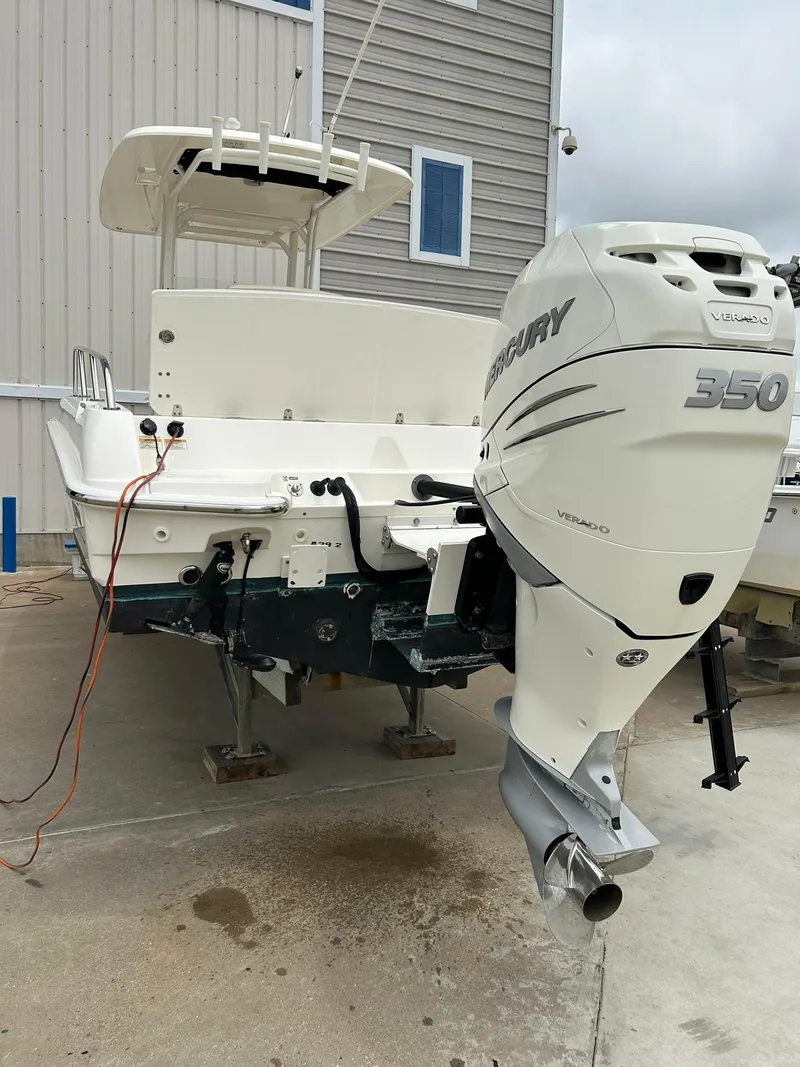Slide: The Image of 2017 Boston Whaler 270 Dauntless with Mercury 350 outboard engine, docked outdoors. - 7