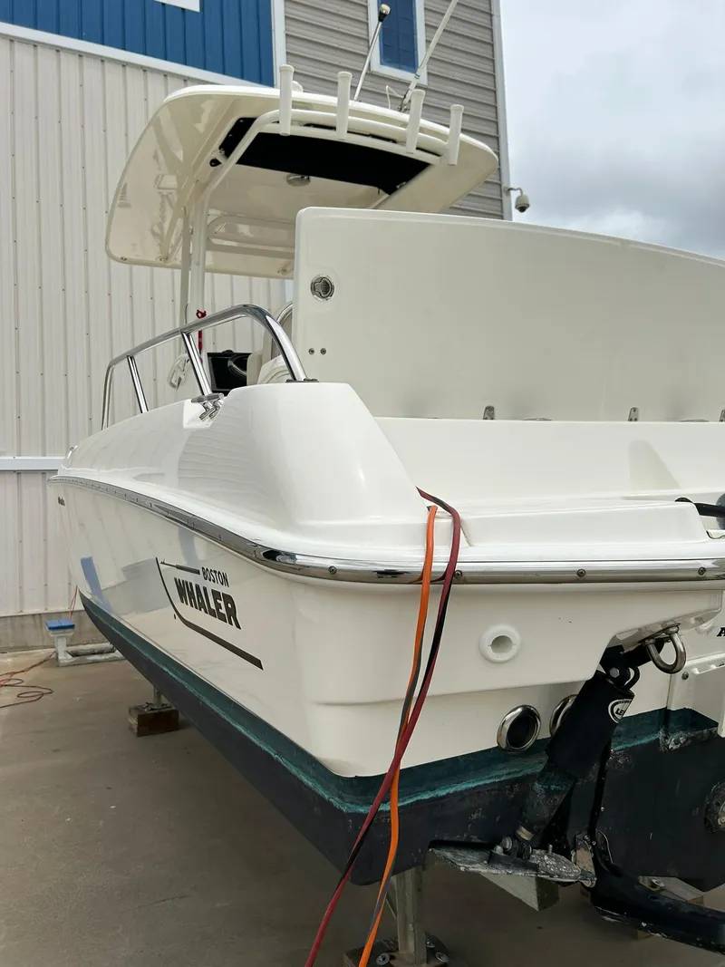 Slide: The Image of 2017 Boston Whaler 270 Dauntless boat docked near a building. - 8