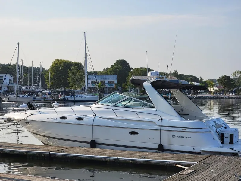 Slide: The Image of 2000 Cruisers 3870 Express yacht docked in a serene marina setting. - 1