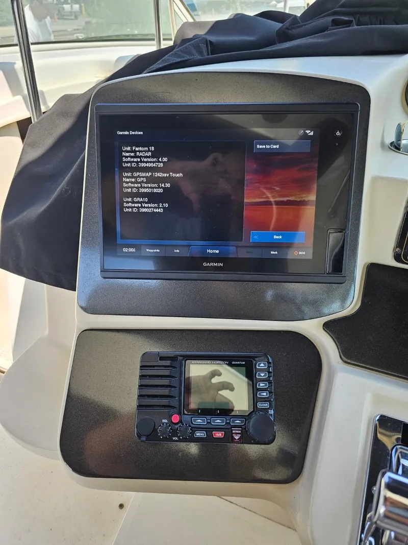 Slide: The Image of 2000 Cruisers 3870 Express boat dashboard with navigation and communication systems. - 10